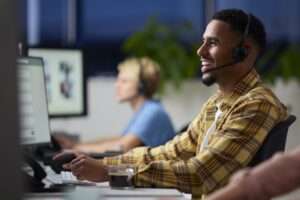 Business Team Wearing Headsets Working Late At Customer Support Centre