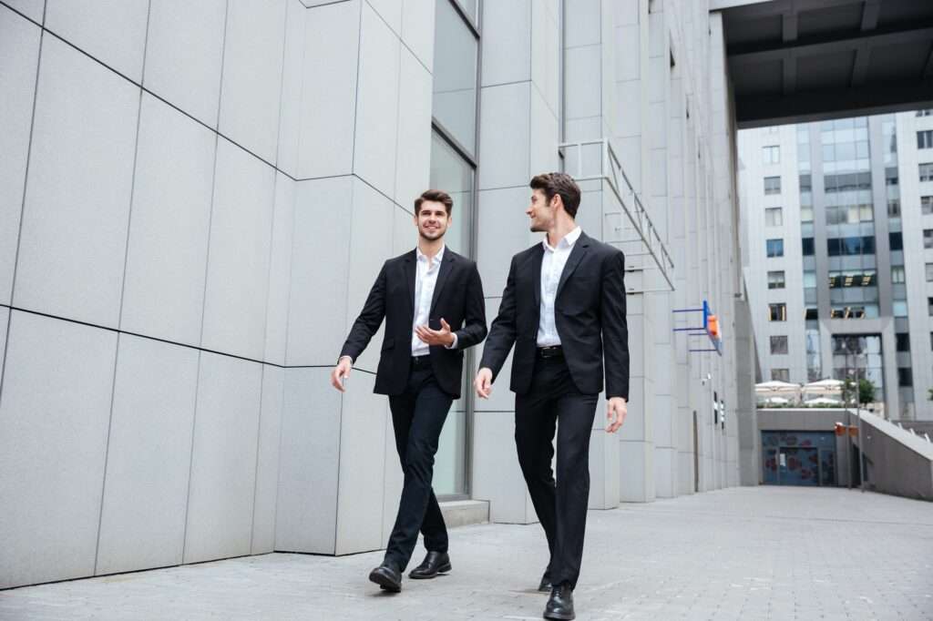 Two businessmen walking and talking in the city